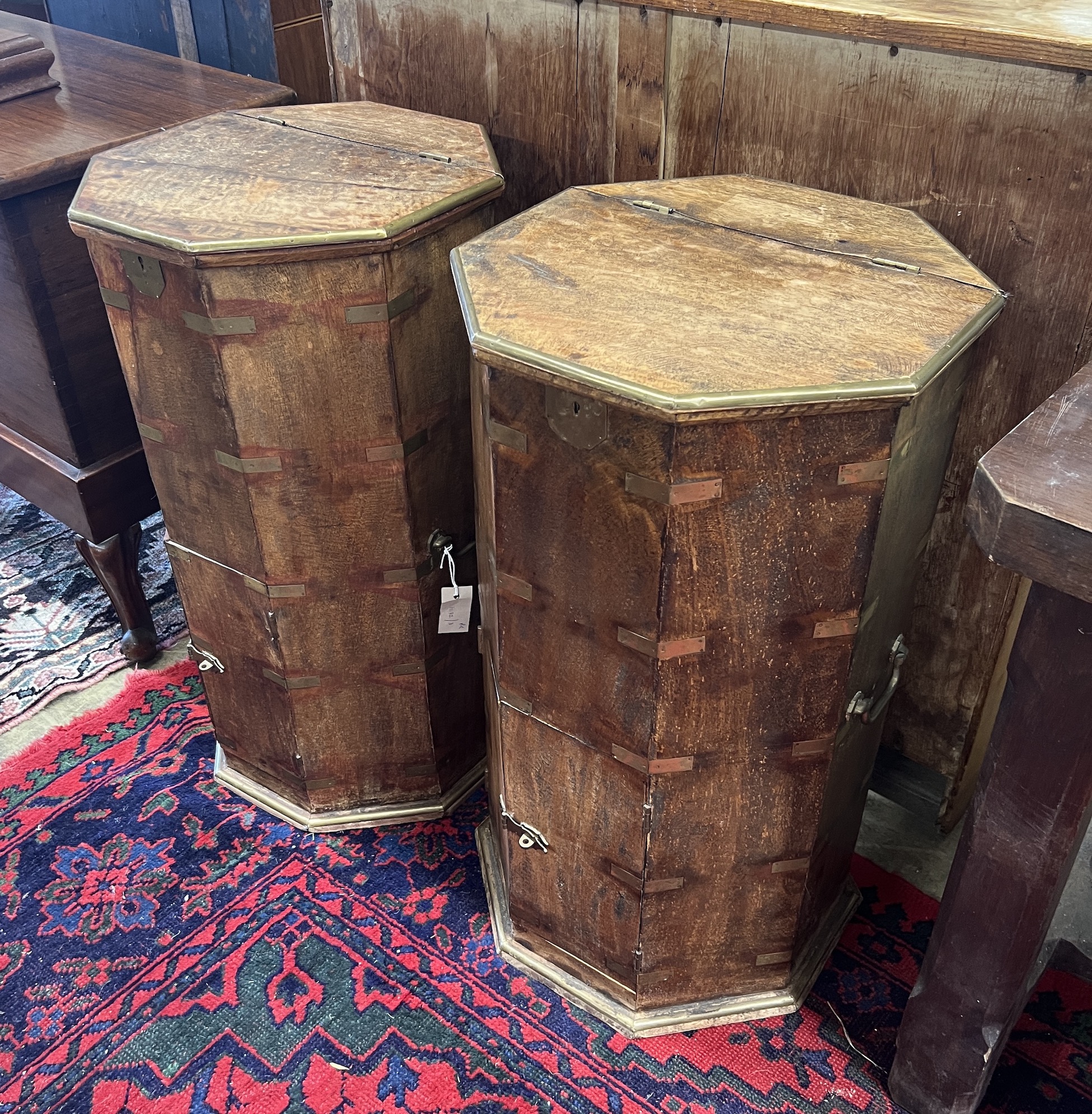 A pair of Indian octagonal brass mounted side cabinets with hinged tops, width 41cm, height 76cm